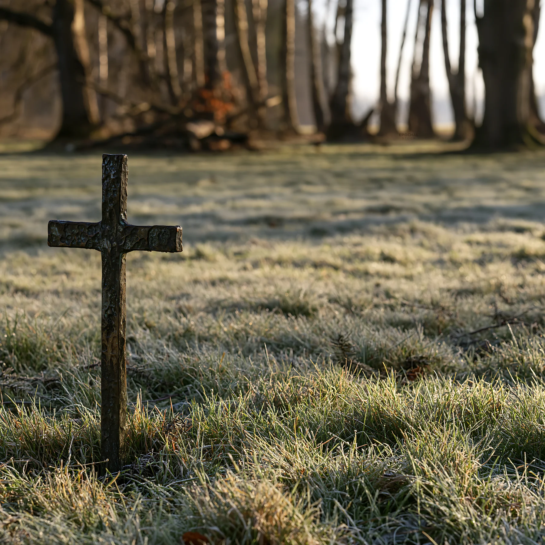 Bronze Christian cross in a Christmas meadow - AI-generated stock image