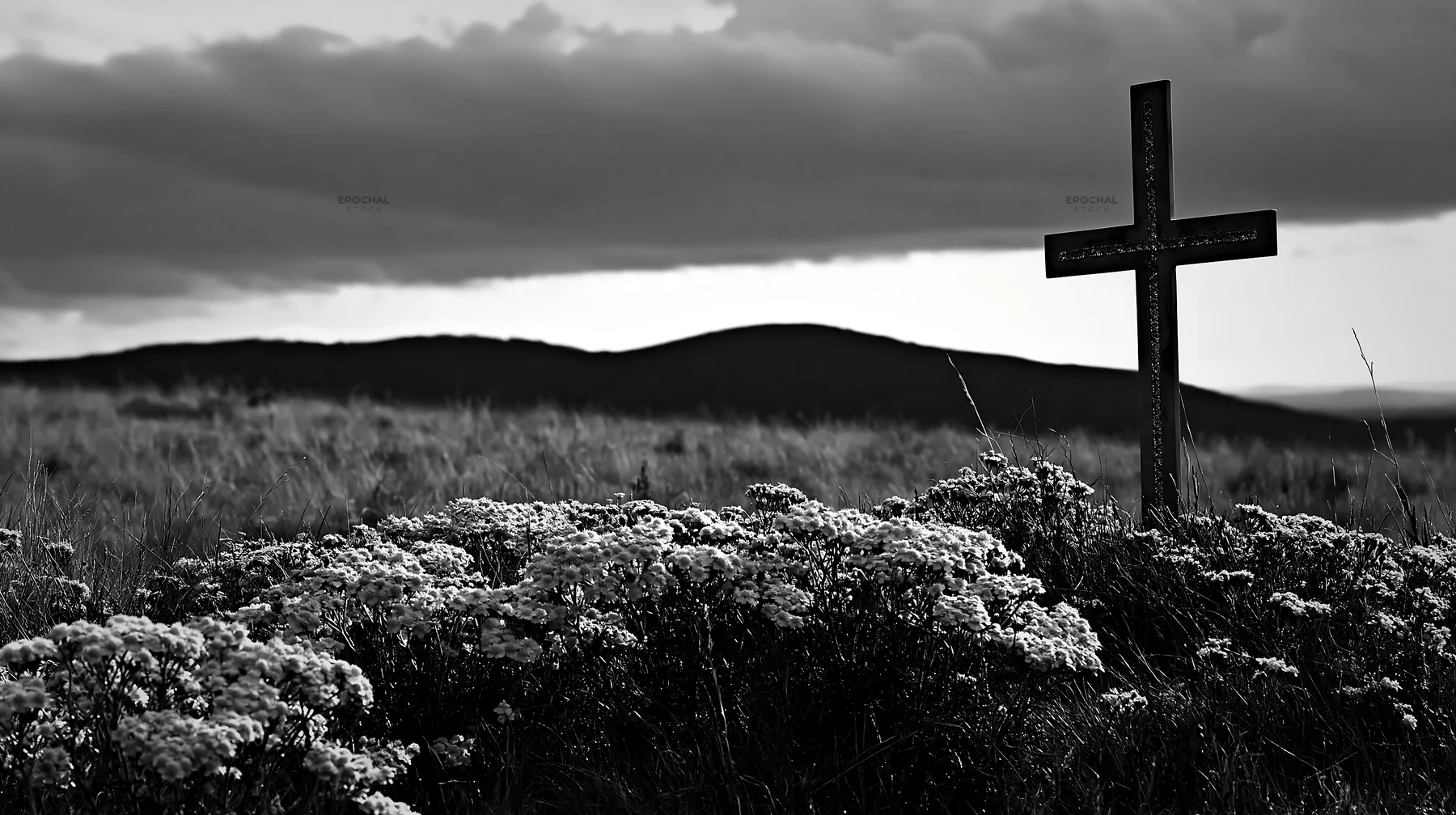 Christian cross in yellow wildflower meadow on cloudy day - AI-generated stock image