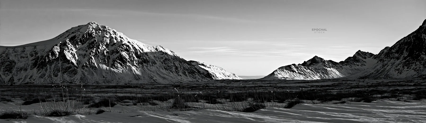 Black and white lofoten coastal meadow winter snow with mountains and blue sky - AI-generated stock image
