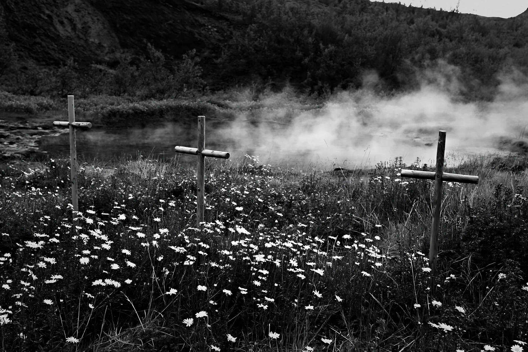 Christian crosses near geothermal spring meadow in nature - AI-generated stock image