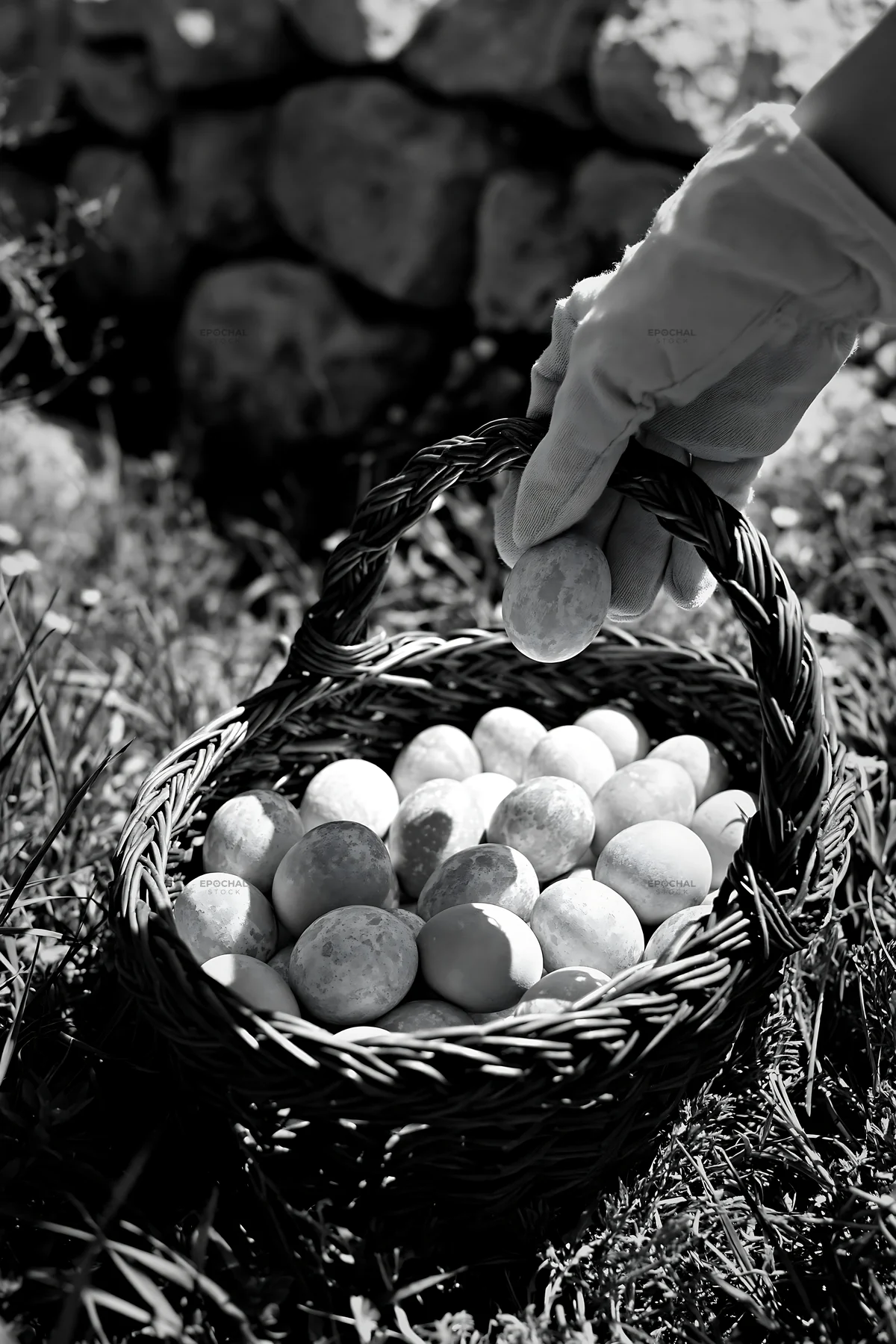 Easter basket filled with eggs in a meadow - AI-generated stock image