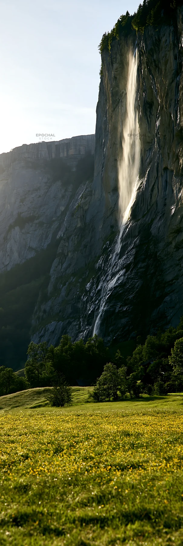 Lauterbrunnen Valley meadow with light rays and waterfall - AI-generated stock image