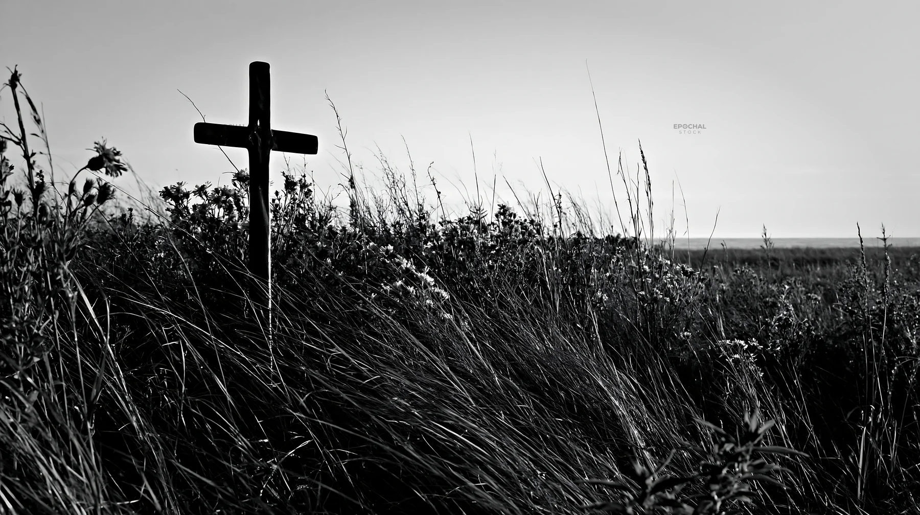 Bronze Christian cross in a Christmas meadow during winter - AI-generated stock image
