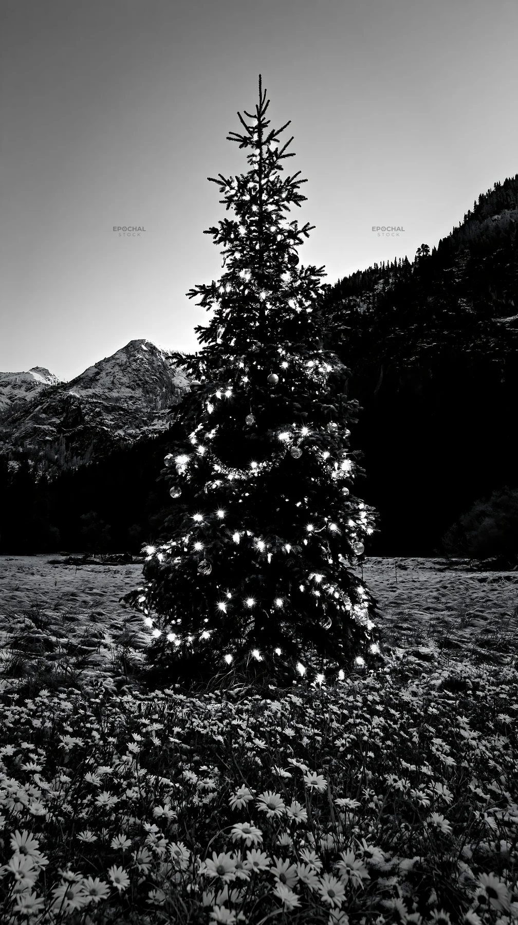 Christmas tree with lights in snowy mountain valley meadow - AI-generated stock image