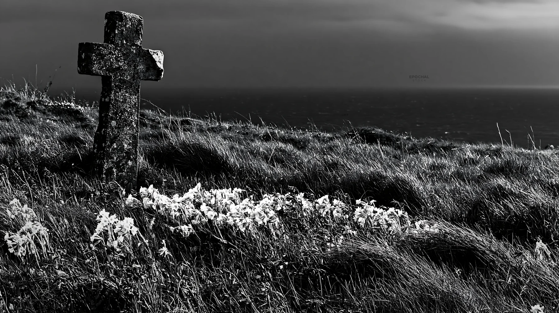 Rustic Christian cross stands in a winter meadow by the sea - AI-generated stock image