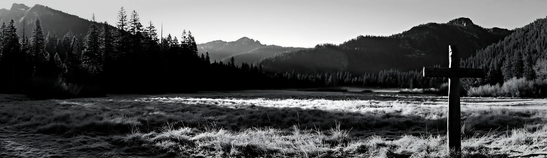 Carved oak cross in frosted meadow near mountains - AI-generated stock image