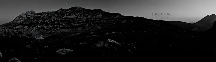 Starlit meadow with mountains in the background - AI-generated stock image