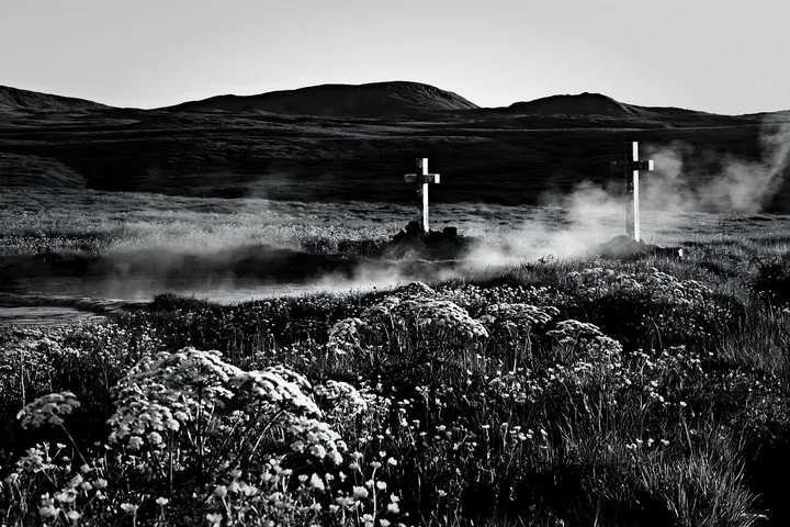 Two Christian crosses near a thermal spring meadow - AI-generated stock image