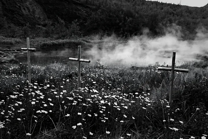 Christian crosses near geothermal spring meadow in nature - AI-generated stock image