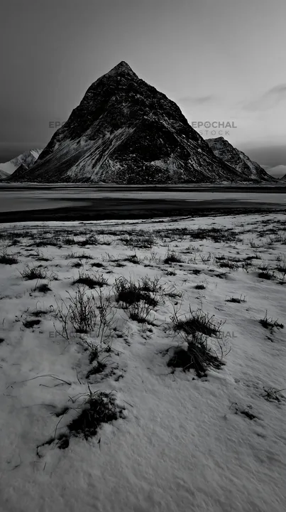 Lofoten coastal meadow with winter snow and mountains - AI-generated stock image