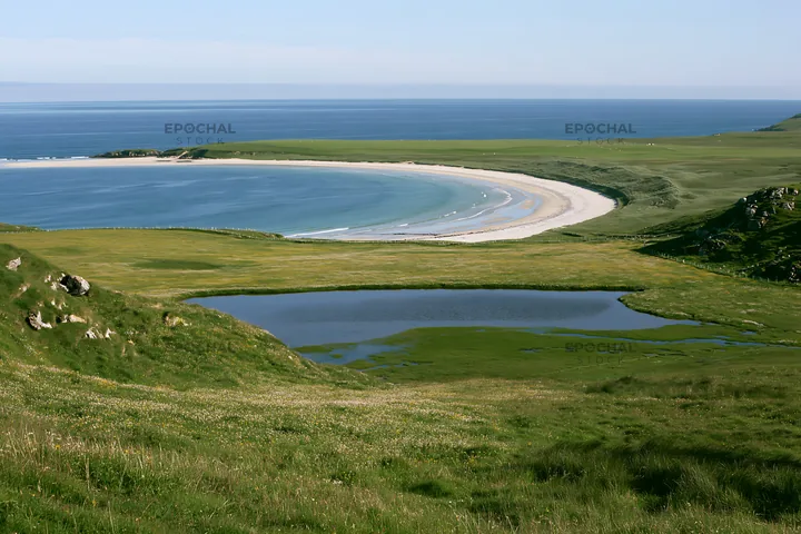 Machair beach meadow with calm water and distant shoreline - AI-generated stock image