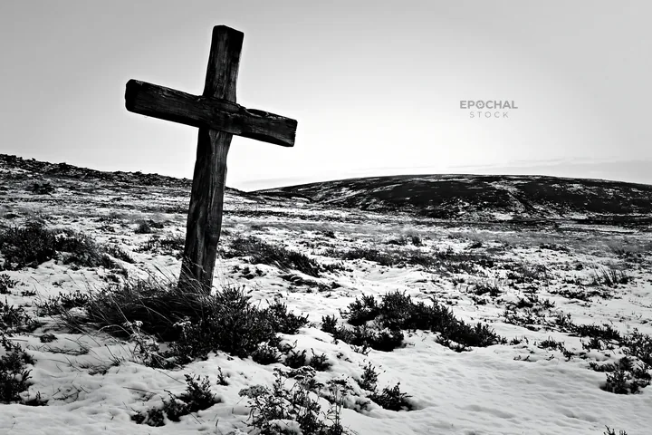 Rustic Christian cross in snow-covered winter meadow - AI-generated stock image
