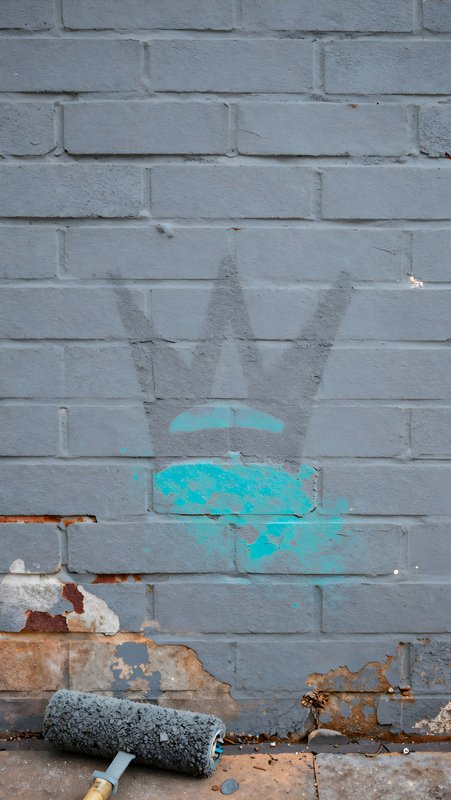 Graffiti art showing a crown symbol on a brick wall Free Premium Stock Photo - stock photo