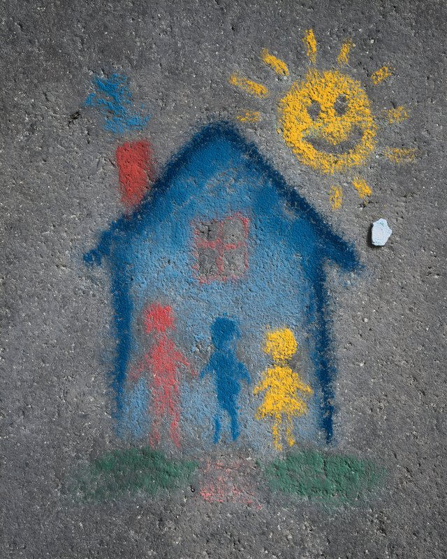 Children draw a house and sun on the sidewalk Free Premium Stock Photo - stock photo