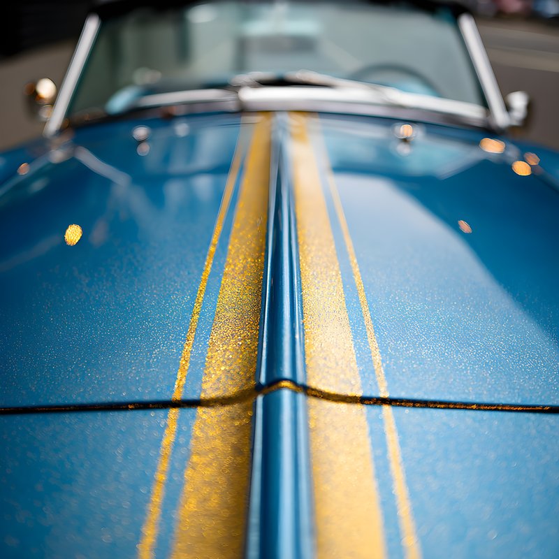 Blue car with gold stripes in a modern garage setting Free Premium Stock Photo - stock photo