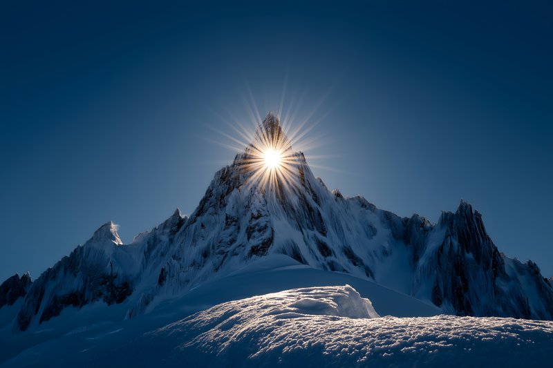Sunrise over mountain peak in blue sky Free Premium Stock Photo - stock photo