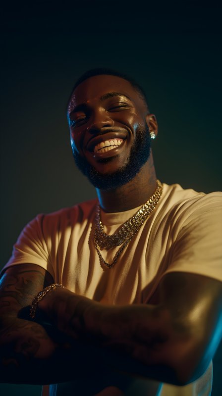 Smiling man standing with arms crossed and wearing jewelry Free Premium Stock Photo - stock photo