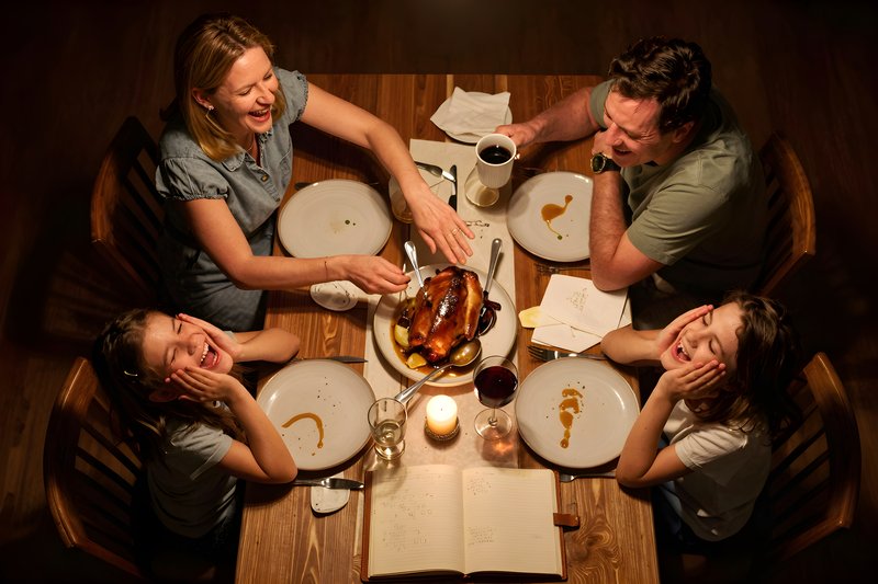 Family dinner around a table with food and smiles Premium Stock Photo - stock photo