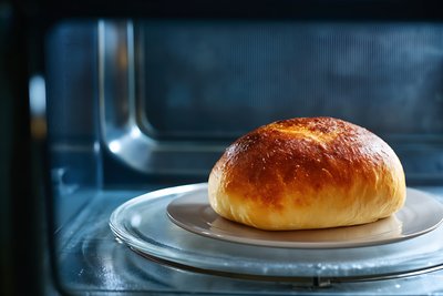Freshly Baked Golden Bierocks on White Plate in Modern Kitchen - stock photo