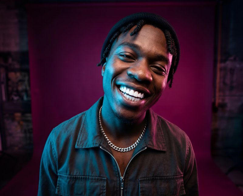 Smiling person in front of colorful background Premium Stock Photo - stock photo