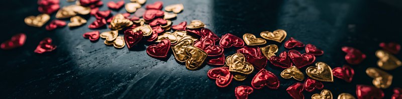 Heart-shaped decorations on a dark surface for celebration Premium Stock Image - stock photo