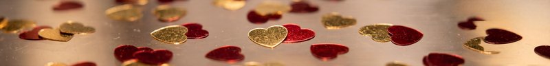 Small hearts on shiny surface create a festive look Premium Stock Image - stock photo