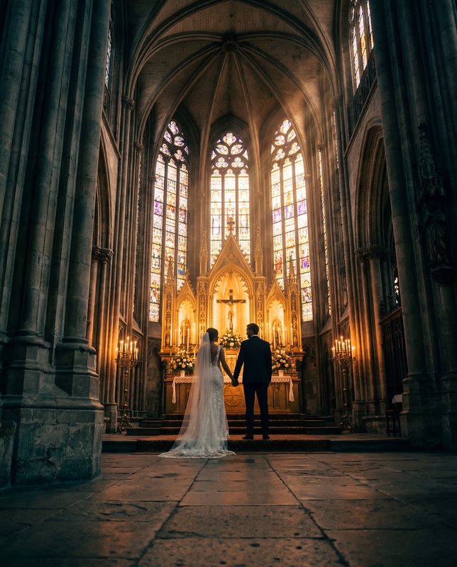 Couple stands together inside a church during their wedding Premium Stock Image - stock photo