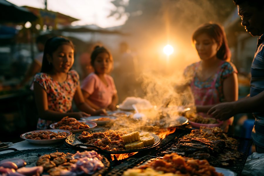 Family Preparing Traditional Festive Food at Sunset