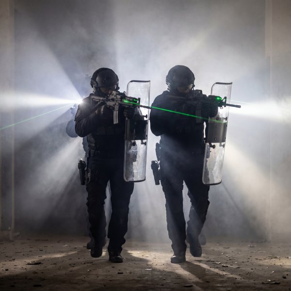 SWAT team conducts training exercise in abandoned building setup - stock photo