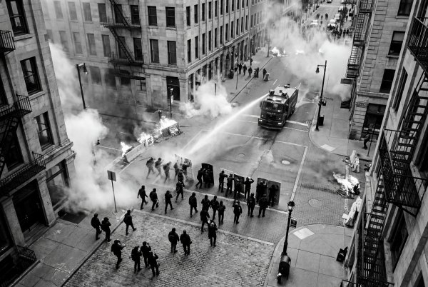 Protesters face police response during a crowd event in the city - stock photo