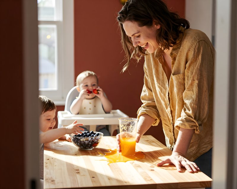 Mother and children enjoy snack time in bright kitchen Premium Stock Image - stock photo