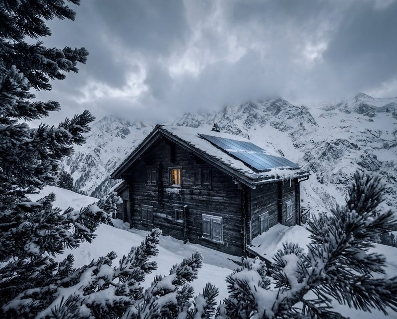 Snow covers a cabin in the mountains during winter Premium Stock Photo - stock photo