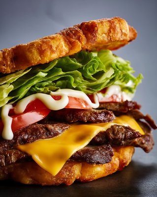 Jibarito Burger with Fried Plantain Bread, Melted Cheese, and Fresh Toppings - stock photo