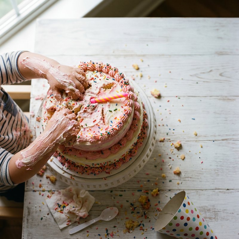 Child plays with cake during birthday celebration at home Premium Stock Image - stock photo