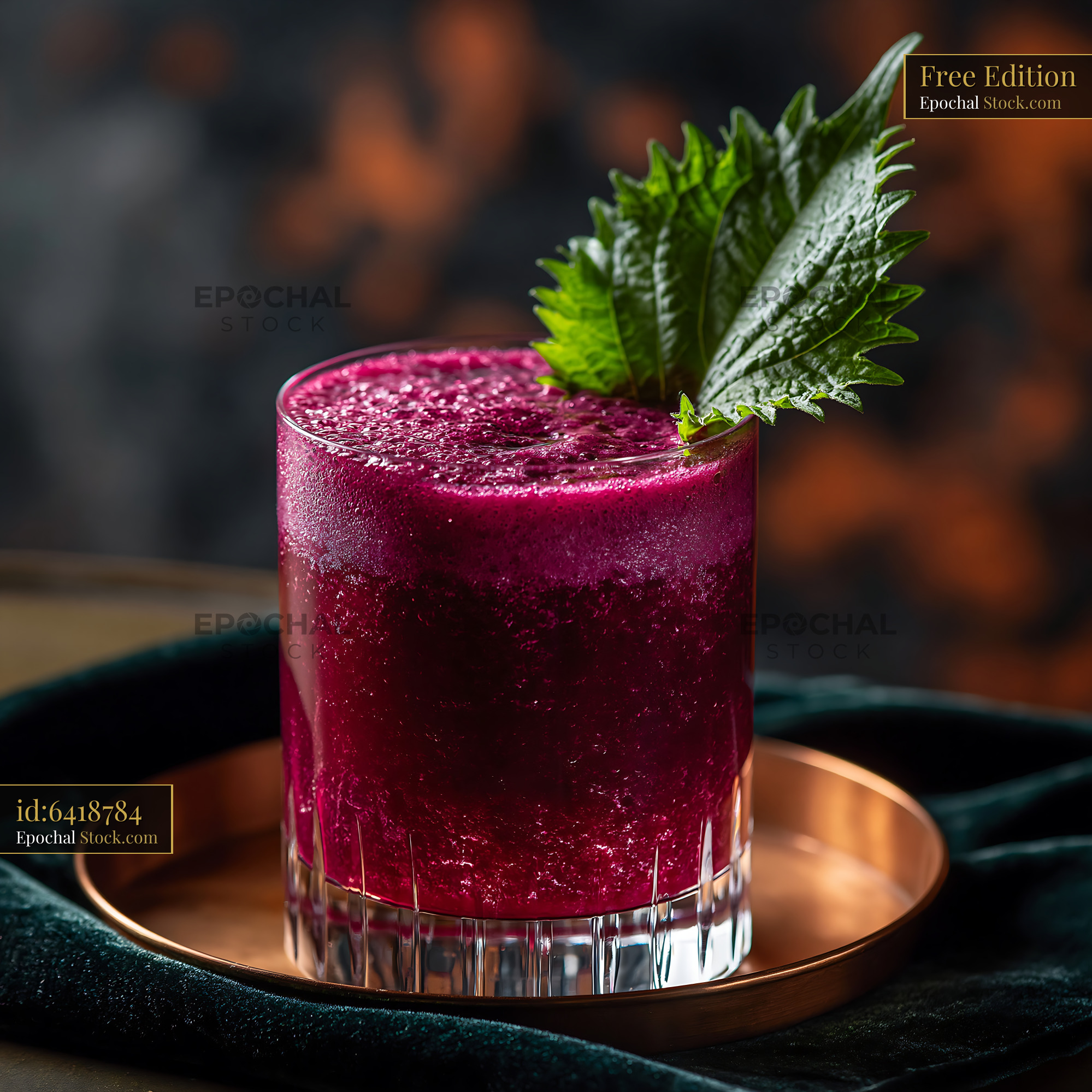Vibrant purple shiso leaf smoothie in a crystal glass on a tray - stock photo