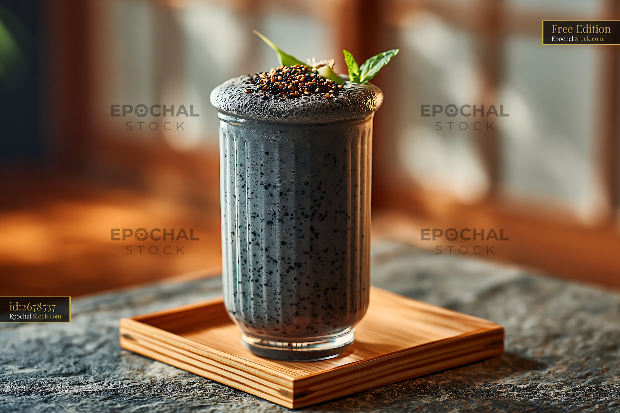 Healthy kurogoma smoothie with black sesame seeds and mint garnish - stock photo