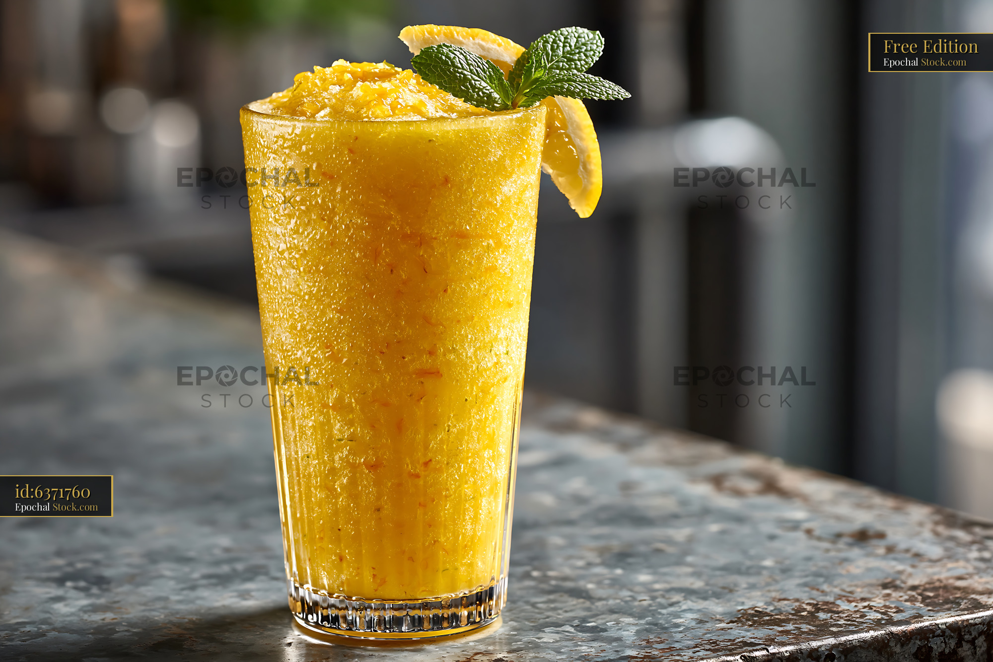 Yuja citron smoothie with mint garnish on a rustic bar counter - stock photo