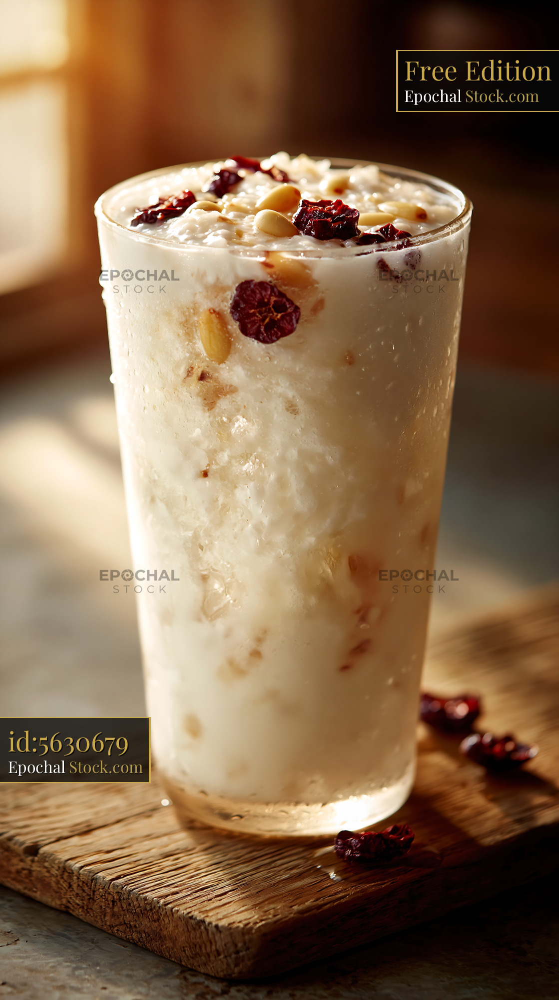 Sikhye rice smoothie with pine nuts and berries in golden sunlight - stock photo