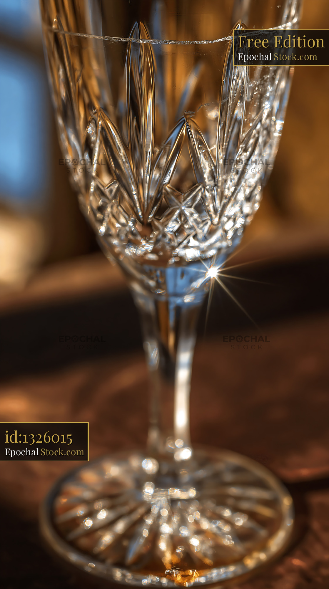 Elegant empty crystal champagne glass with sparkling golden light - stock photo