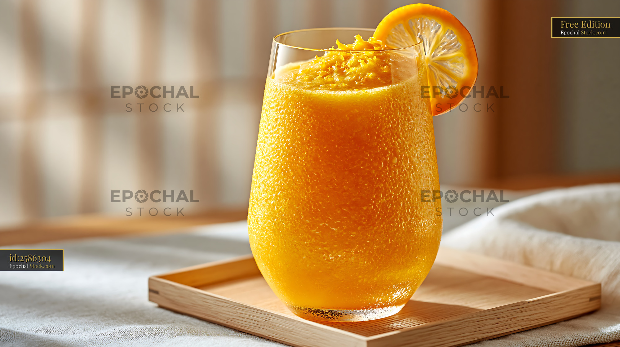 Refreshing mikan orange smoothie served on a wooden tray - stock photo