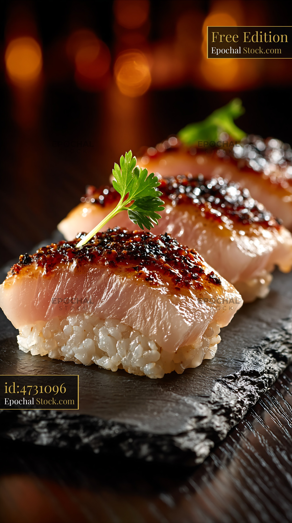 Seared truffle yellowtail sushi nigiri on a black slate board - stock photo