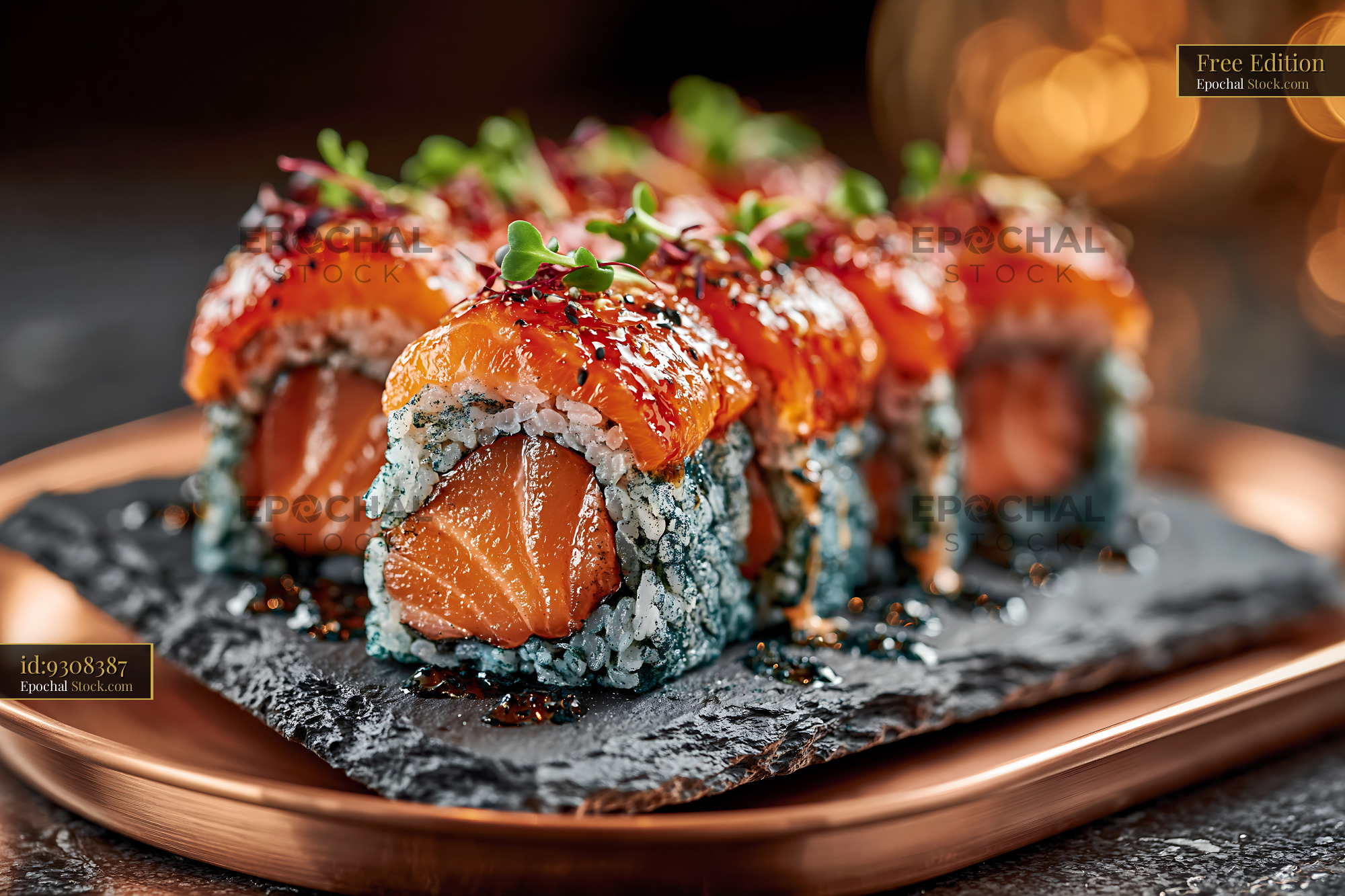 Gourmet salmon sushi rolls with blue spirulina rice on slate plate - stock photo