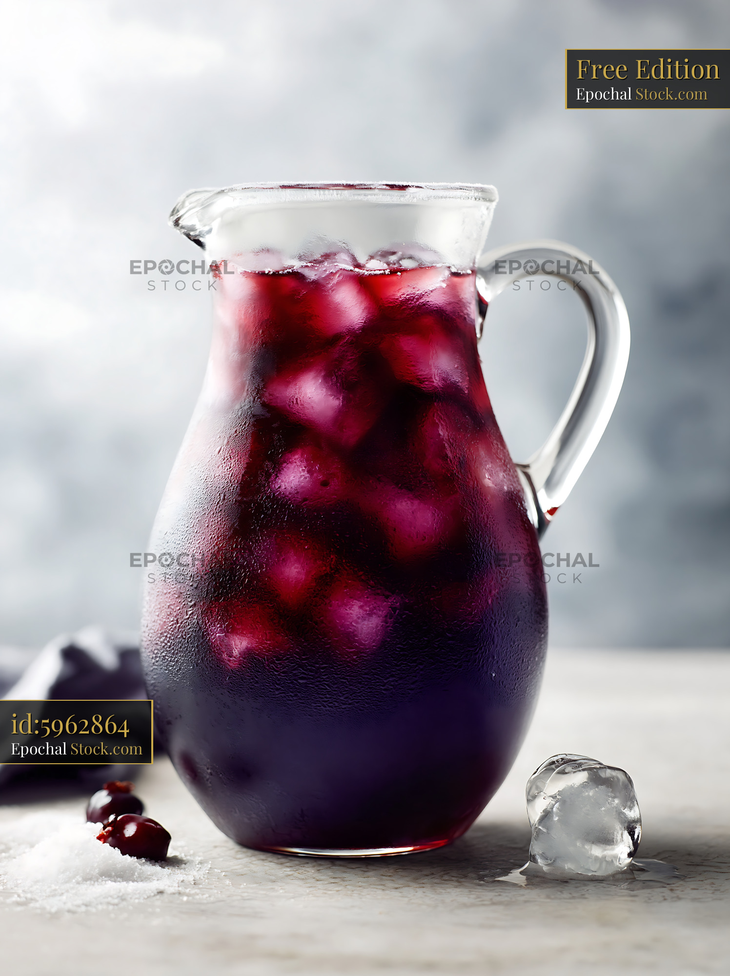 Chilled berry lemonade pitcher with ice cubes and condensation - stock photo