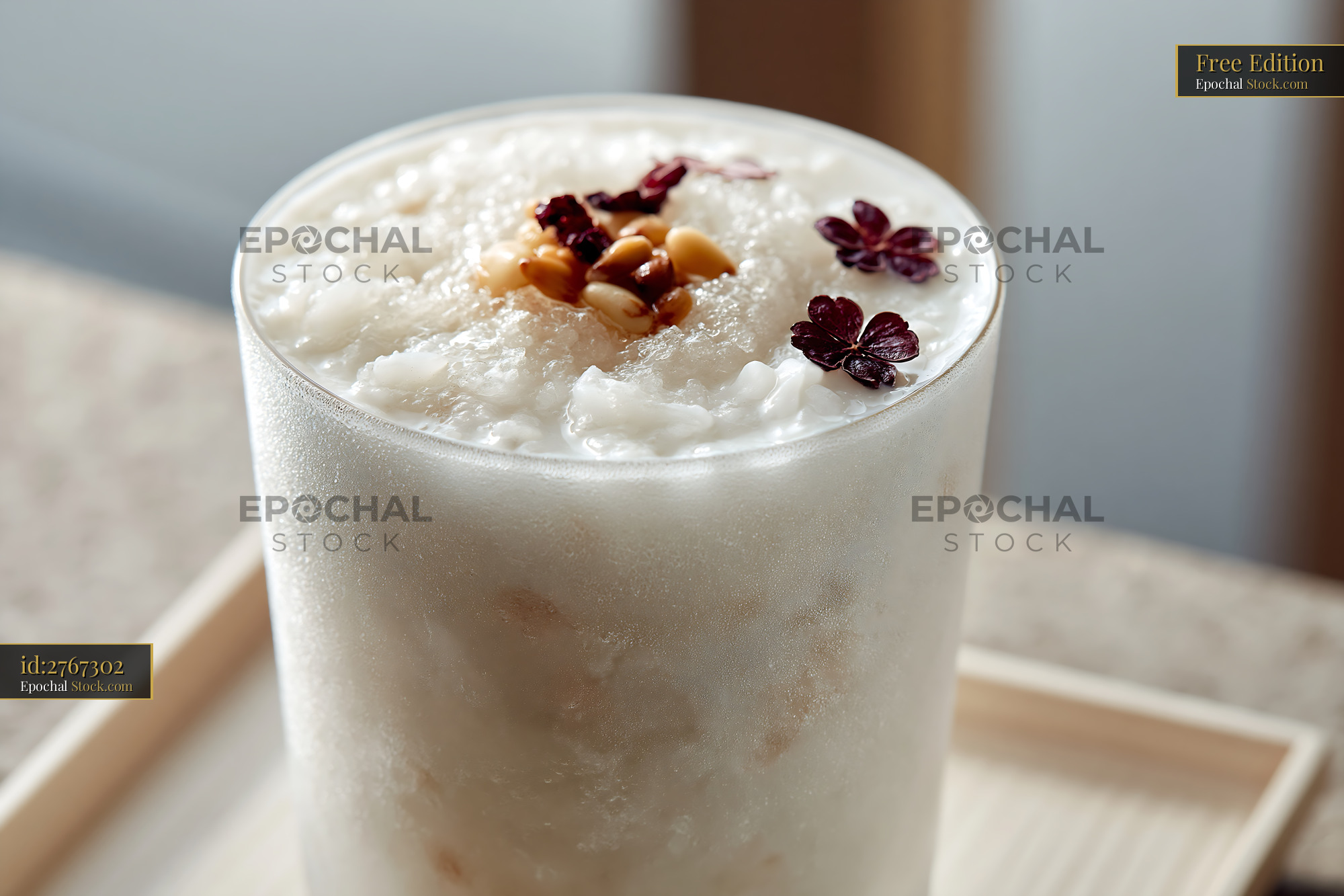 Chilled sikhye rice smoothie with pine nuts and edible flowers - stock photo