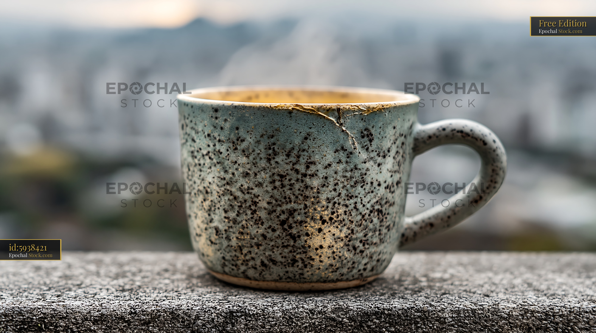 Steaming ceramic coffee cup with kintsugi repair on a city balcony - stock photo