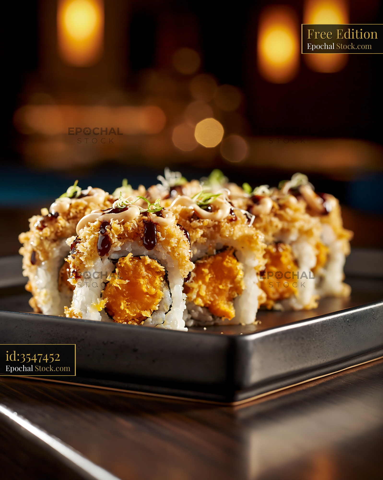 Gourmet sweet potato crunch sushi rolls on a black plate - stock photo