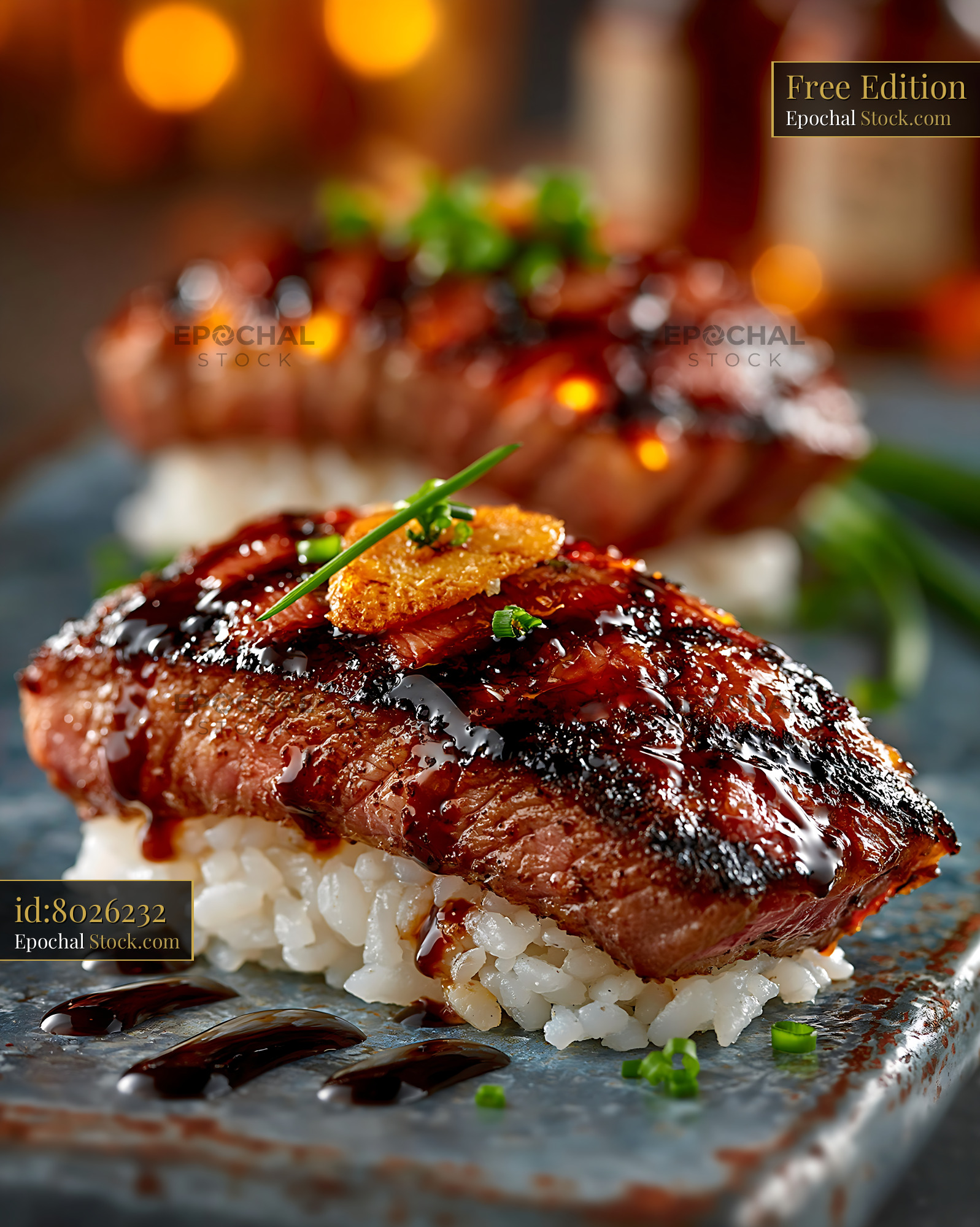 Aburi wagyu sushi with seared beef and glaze on a dark plate - stock photo