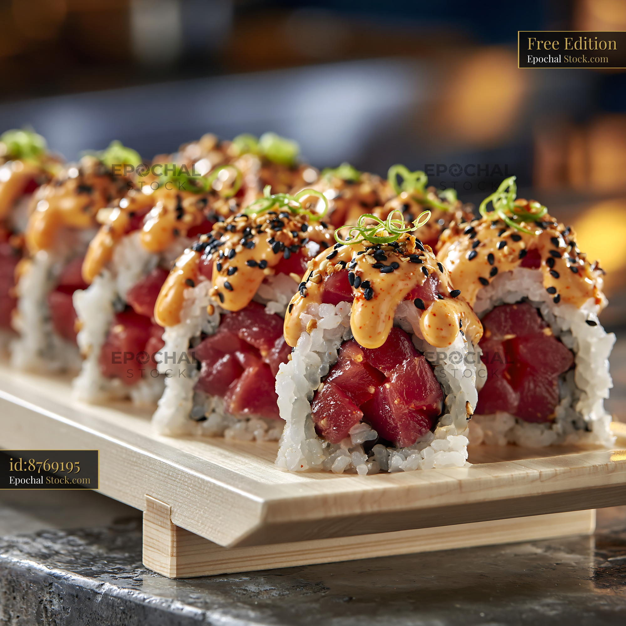 Sriracha mayo tuna sushi rolls topped with sesame and scallions - stock photo