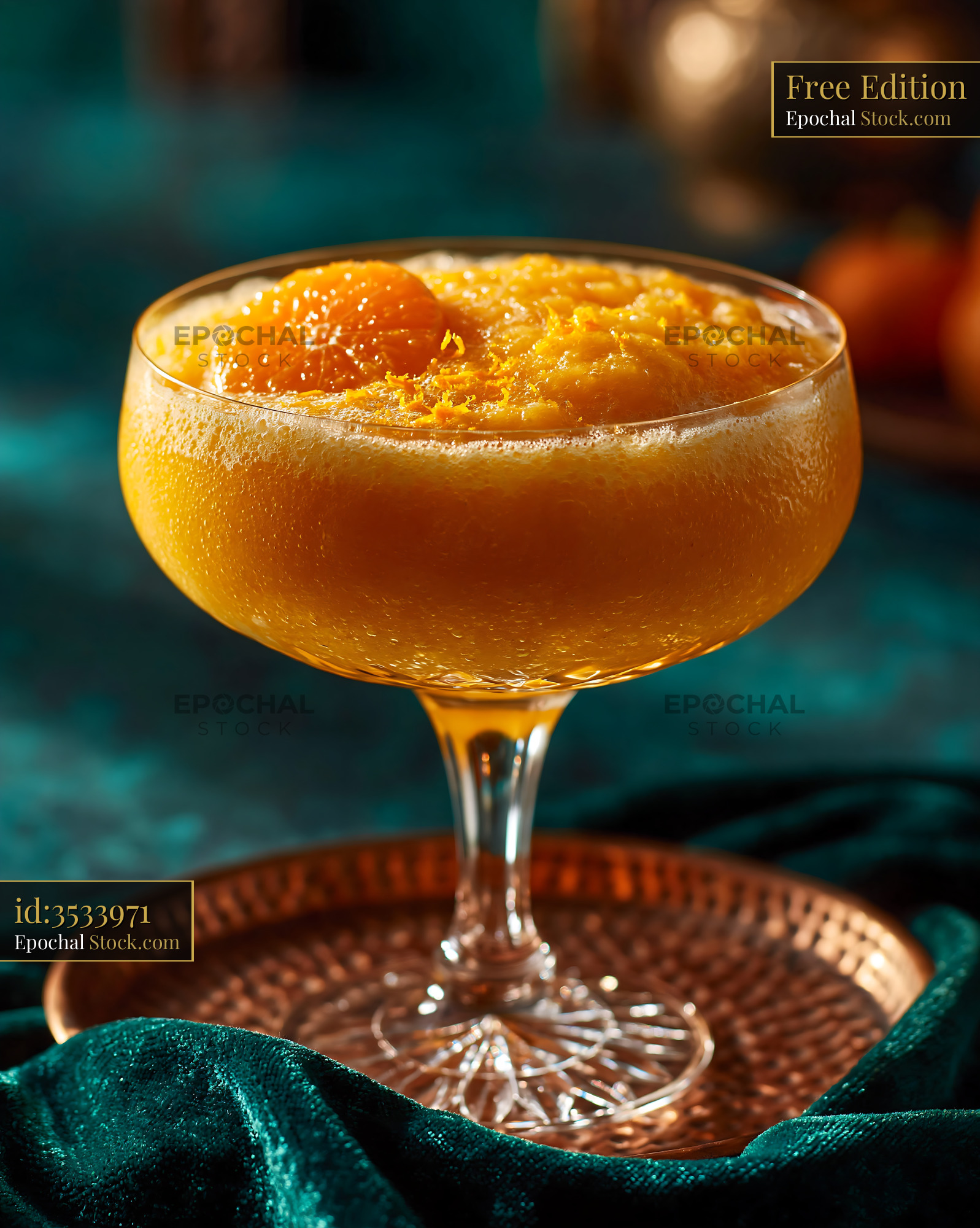 Mikan orange smoothie in a crystal glass on a copper tray - stock photo