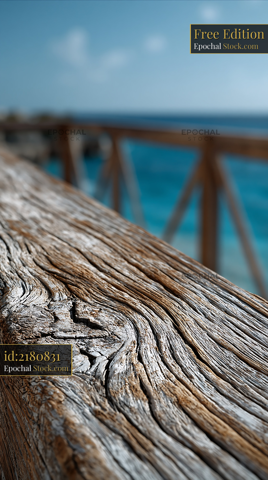 Weathered wooden railing on a luxury hotel balcony overlooking the oce - stock photo